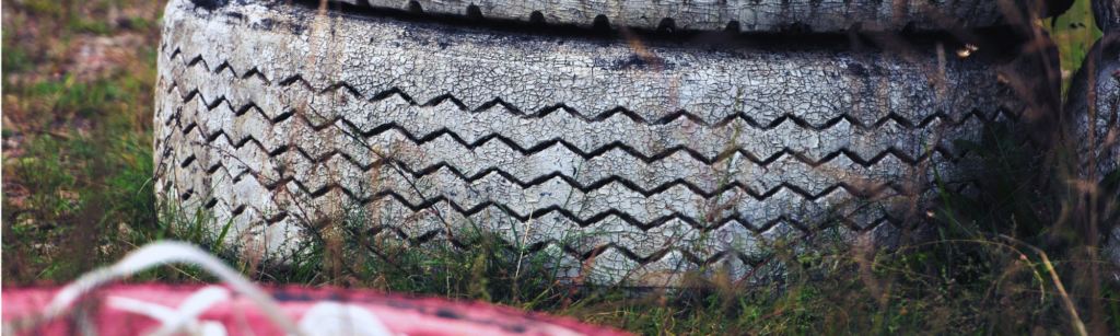 Used tire pile sitting on grass